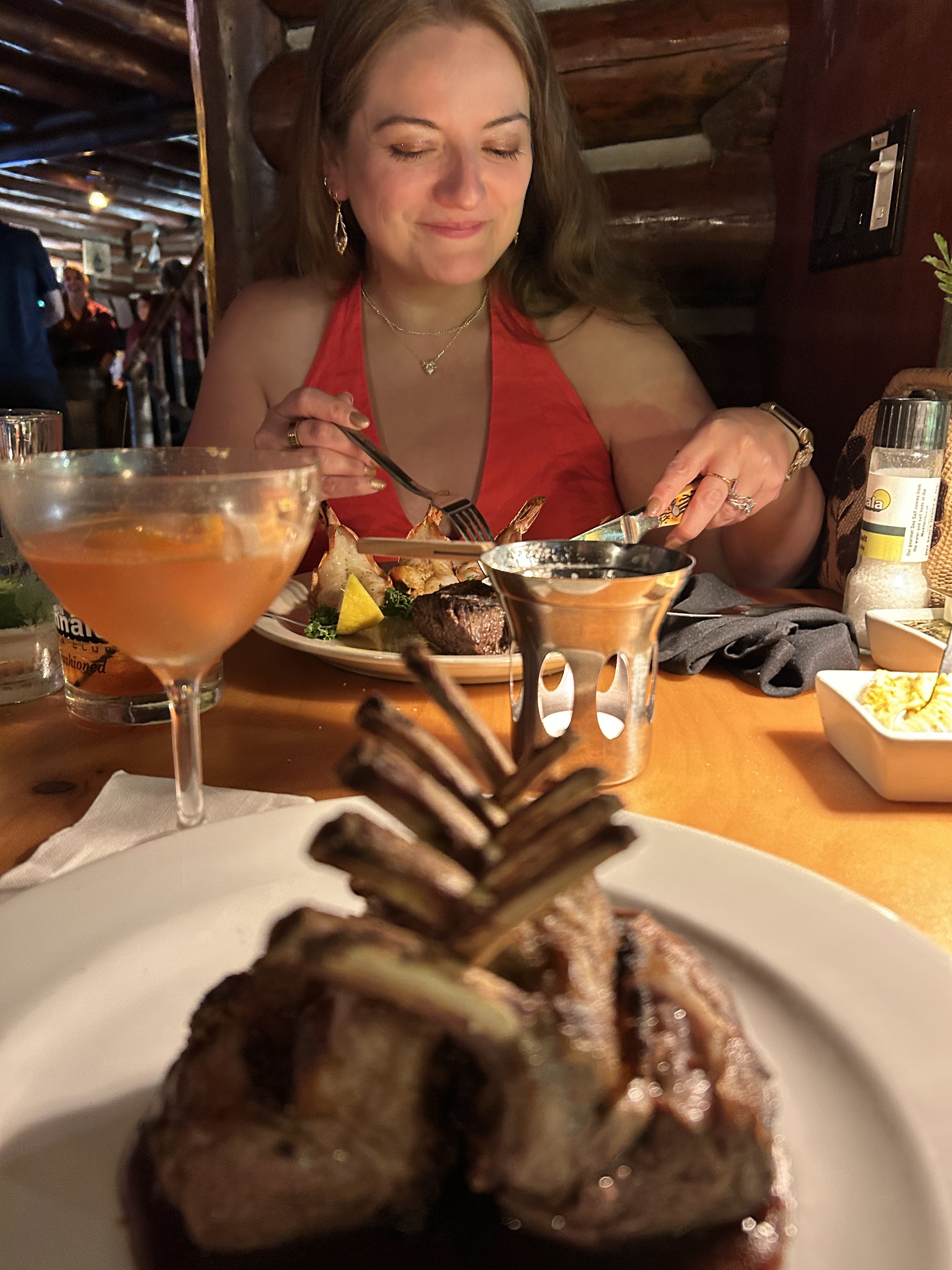 eating with a rack of lamb in the foreground